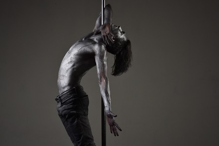 performance of pole dance. performance of silver man on pylon.の写真素材