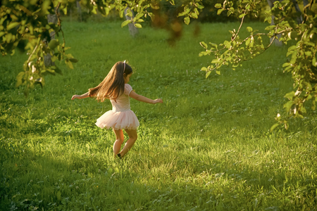 children enjoy outdoor recreation. Child with long hair in fashionable dress, fashionの写真素材