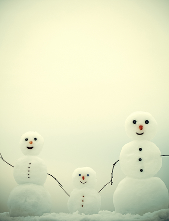 family of snowmen. New year mother, father and child from snow. Happy holiday and celebration. Love and trust. Snowman family in winter outdoor. Christmas or xmas decoration.の写真素材