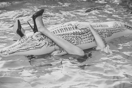summer rest. Fashionable woman posing. shoes from crocodile leather. Fashion shoes from crocodile...