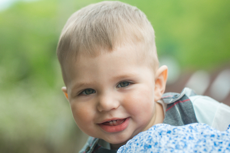 Toddler boy smiling with baby teeth on cute faceの写真素材