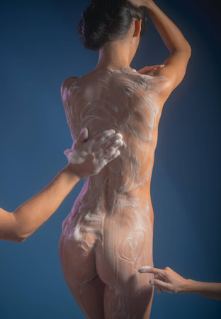 man wash naked woman with wisp in hand. Sex games desire and orgasm. girl sexy body relax in shower. Massage and family spa concept. Total relaxation. Love relations in bath with foamの写真素材