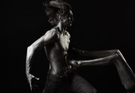 passion concept. passion of man holding female legs painted in silver.の写真素材