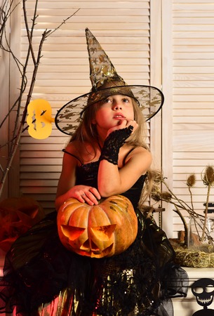 Witch girl with carved jack o lanternの写真素材