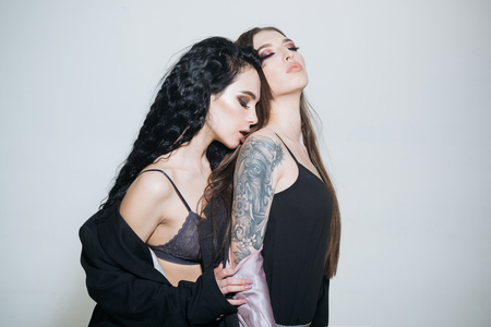 Tattoo concept. Women with tattoo. Sensual tattoo models. Tattoo salon. No pain no gainの写真素材