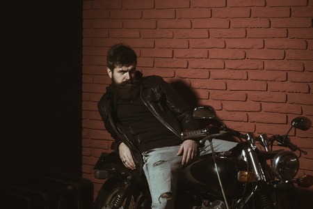bearded man. bearded man in leather jacket. bearded man relax on motorcycle. bearded man biker with...