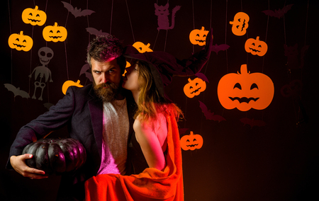 Couple dressed in vampire and witch costume against Halloween background.の写真素材
