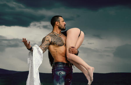 Naked woman and young man. Couple in love. Night Party background. Beautiful passionate couple is after sex. Erotica and underwear. Valentines day.の写真素材