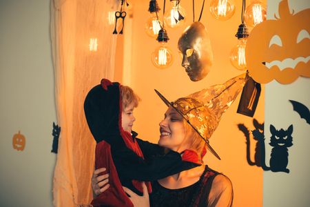 Background decorated for Halloween. Magic pumpkin. Magic hat. Halloween party for mother and son. Ready for text. Children play with mother pumpkins and treat. slogan or product.の写真素材