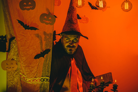 Halloween Witch with a carved Pumpkin and magic lights in a dark forest. Halloween background....