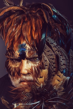 bearded old man in feather hat