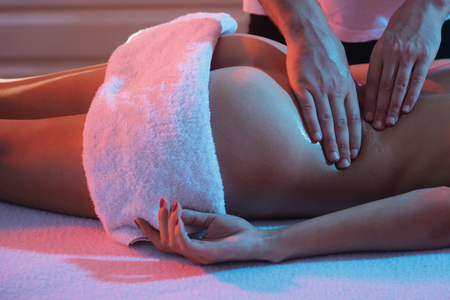 Professional massage at home. Ideal womans butt anti-cellulite and skin care. Massage and body care. Massage Therapy for Health Purposes. Massage Oils and Scented Body Oil. Relaxの写真素材