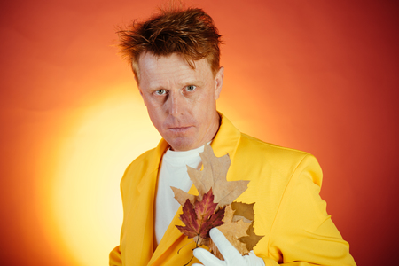Funny red-haired man advertises your products. Banner for advertising of autumn clothes. Model with...