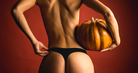Sexy Model Posing In Lingerie on halloween background. Female with sexy ass posing. Fashion Glamour Halloween art designの写真素材