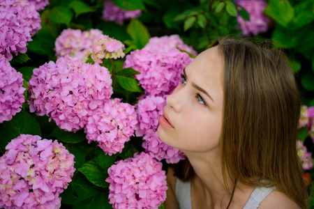 Spring style. Pretty girl with spring flowers. Adorable girl in spring. Beauty treatment and therapy. Beauty salon. Pure beautyの写真素材