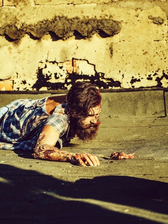 Zombie man lies on asphaltの写真素材