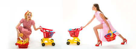 retro women go shopping with full cart. happy shopping girls with full cart. savings on purchases. online shopping app. vintage housewife women going to make payment in supermarket. home deliveryの写真素材