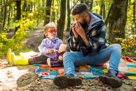 Parent teach baby. Happy family, father and baby son playing and laughing on autumn walk.