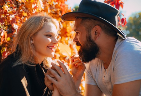 Close up portrait of autumn couple in love. We like autumn time together. Happy couple having fun in autumn park.の写真素材