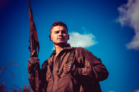 Portrait of hamdsome Hunter. Hunter with shotgun gun on hunt.