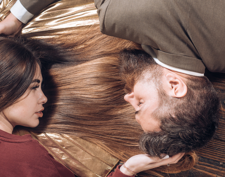 Brunette girl with long and shiny wavy hair. Beautiful model with curly hairstyle. Fashion haircut. Trendy haircuts. Barbershop and Barber salon concept.の写真素材