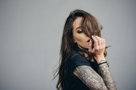 American latinos woman. Sexy brutal girl with tattoo. Stylish woman - casual clothing. Beautiful attractive Fashion woman. Care and hair products.の写真素材