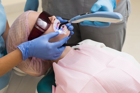 Comparison after teeth whitening. Teach patients about diets, flossing and other aspects of dental care. Make models and measurements for dental appliances, such as dentures, to fit patients.の写真素材