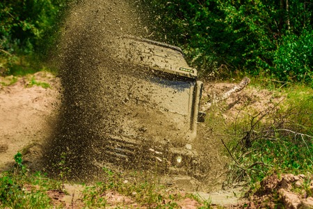 Adventure travel. Motion the wheels tires and off-road that goes in the dust. Rally racing.の写真素材