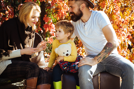 Autumn camping with kids, mom and father. Happy family concept. Little traveler and happy parents traveling together.の写真素材
