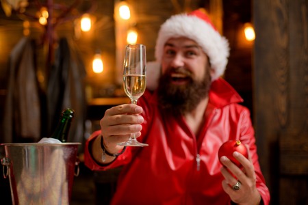 Santa wishes Merry Christmas. Portrait of a brutal mature Santa Claus. Modern man in red santa claus suit.の写真素材