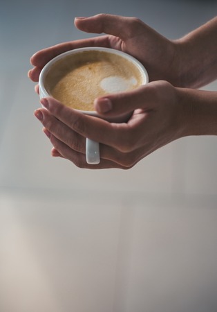 barista propose americano or espresso cup. relax in cafe or coffee shop and drinking. fresh morning coffee with milk and cream froth. perfect morning with best coffee. Five minutes for coffeeの写真素材