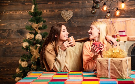 Group of friends celebrating new year and merry Christmas. hristmas hot mulled wine. Funny girls and friendship concept. We begin the new year in that spirit of hope.の写真素材