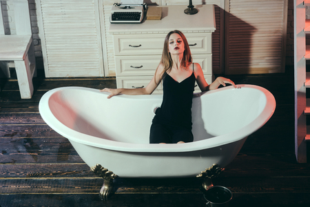 Beauty salon and hairdresser. Fashion portrait of woman. Girl in stylish cloth with long hair. Following her personal style. Beautiful fashion woman in bath. Beauty and fashion. Makeup. Facial careの写真素材