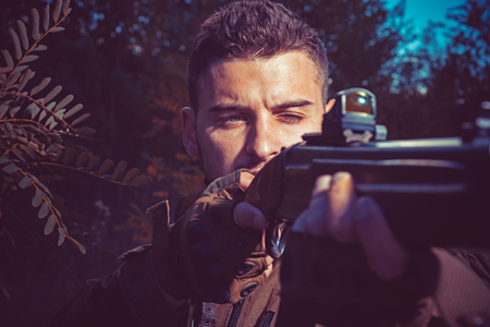 Collimating sight. Hunter hunt with shotgun gun on hunting. Closed and open hunting season. Track down.の写真素材