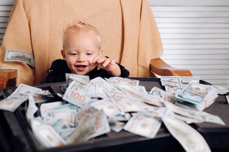 Little boy count money in cash. Little entrepreneur work in officeの写真素材