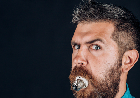Mature hipster with beard. Bearded brutal man. man. male with beard. bearded man with lamp in mouth. brutal caucasian hipster with moustacheの写真素材