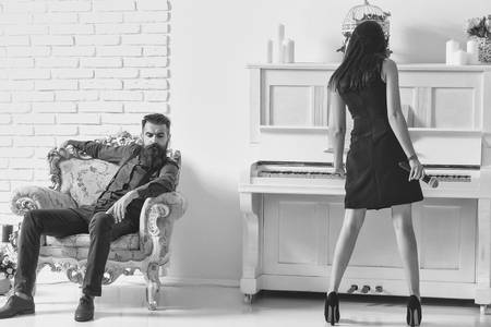 Girl plays piano and man listensの写真素材