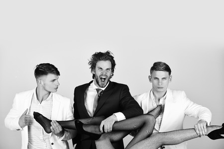 sexy legs of woman body and shouting man with guysの写真素材