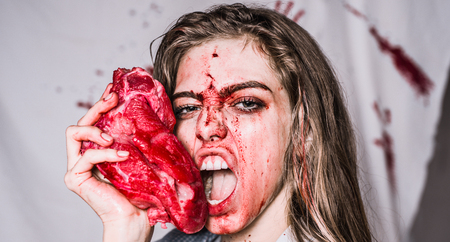 Steak concept. Hungry woman with meat steak. Hungry emotional angry woman screaming. A sensual...