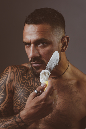 Shaving gel or shaving cream. Hair Preparation is just for the dashing chap. Bearded client visiting barber shop. Protection after shaving.の写真素材