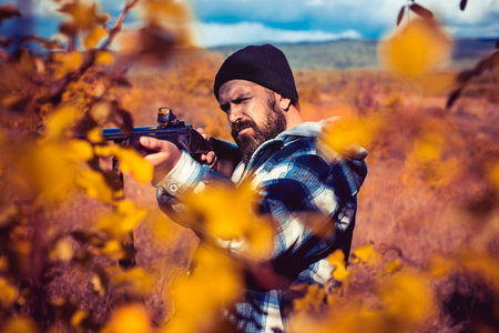 Autumn hunting season. Hunter with shotgun gun on hunt. Autumn.の写真素材