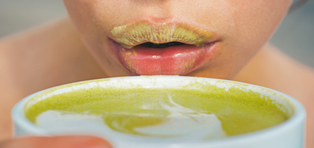 woman drink japanese tea from cup. woman relax in cafe and drinking. matcha latte tea ceremony of girl. perfect morning with green coffee, sexy lips. More tea. Relaxing at home. Relaxing at homeの写真素材