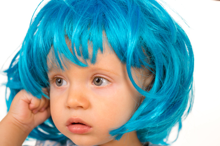 Funky style beauty. Cute baby with long blue hair. Small child wear blue wig hair. Small kid in fancy wig hairstyle. Adorable little child in fashion wig. Beauty look hairstyle for cosplay partyの写真素材