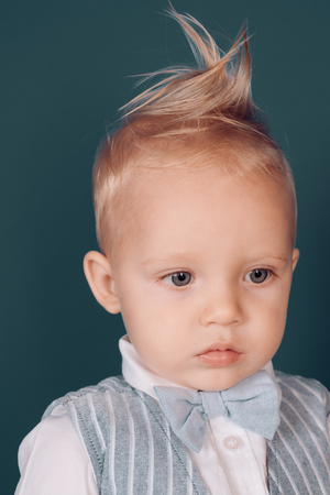 Be natural is more stylish. Small boy with stylish haircut. Boy child with stylish blond hair. Small child with messy top haircut. Healthy hair care habits. Hair styling products.の写真素材