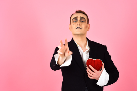 Passionate and poetic. Mime man hold red heart for valentines day. Mime actor with love symbol. Love confession on valentines day. Theatre actor pantomime falling in love, copy space.の写真素材