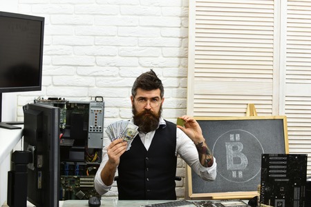 Crypto currency mining hardware. Bitcoin miner man in server room. Bearded man bitcoiner. Bearded...
