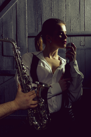 woman with microphone and man with saxの写真素材