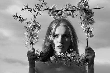 woman with cute face in floral frameの写真素材