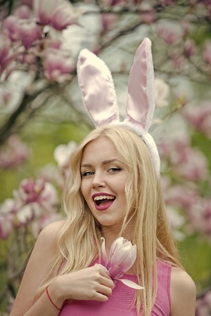 woman smiling with cute, bunny ears at magnoliaの写真素材