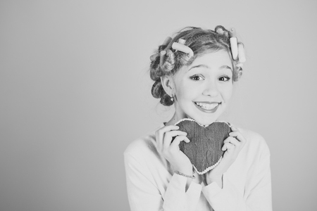 Little girl hold heart, fathers, mothers day.の写真素材